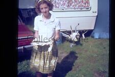 35mm Slide 1970 woman posing With freshly caught Fish Caravan in background