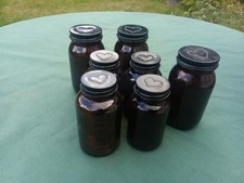Bottles x 7. Brown body with black tops. Glass jars with hearts on lids.