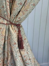 Ivory curtains with a pastel paisley design made from Harlequin Fabric.