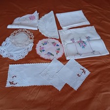 Vintage linens including embroidered doiles, table runner and dressing table set