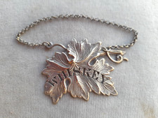 Lovely old plated whiskey decanter label very ornate.