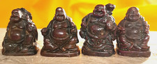 FOUR SMALL STAINED RESIN BUDDHAS