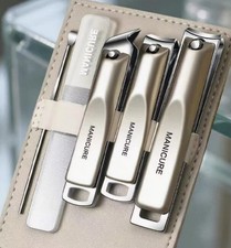 A set comprising nail clippers, nail scissors and an ear pick, presented