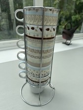Nest of 6 Next smaller brown yellow & blue stacking mugs cups with metal stand