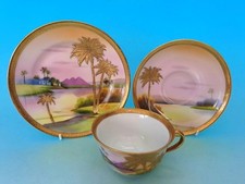NORITAKE TRIO SAHARA SCENE TOOLED & HEAVILY GILDED WITH PALM TREES - NIPPON 1of2