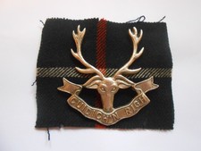 SEAFORTH HIGHLANDERS  cast silver cap badge with backing cloth