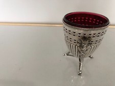 SILVER PLATED PRESERVE JAR WITH A RED GLASS LINER WITH RAMS HEADS ON THREE LEGS