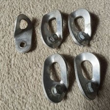 Five Petzl climbing bolt hangars