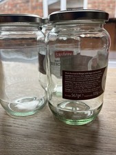Three large glass jars for pickling or storage with lids