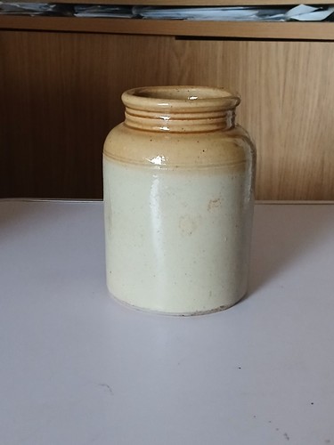 Old stoneware jar with honey - old,