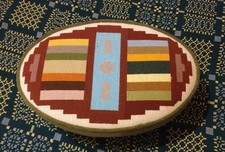 Small oval stool. Tapestry cover. Wooden legs. 16in x 10.5in. 6.5in high.