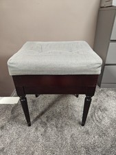 Piano stool with cushioned storage seat.