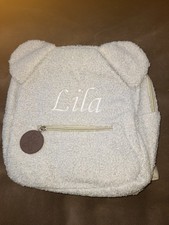 Younger Girl's Grey Teddy Bear