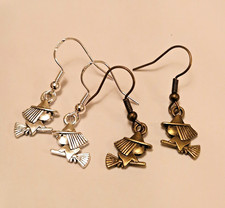 Tiny witch earrings in a
