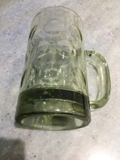 Vintage dimpled glass beer mug shimmers green