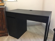 black office desk; compact with cable management hole. 