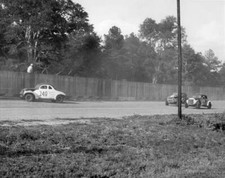 1950s driver sits top fence