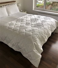 Large white embroidered bed