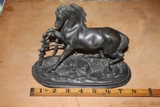METAL POSSIBLY SPELTER FIGURE OF A HORSE WITH LEG TRAPPED  ON A FENCE