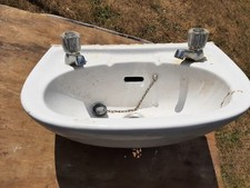 BASIN- SMALL CLOAKROOM/ WC TWO TAP HOLE C/W TAPS & WASTE (USED)  66 X 29CM