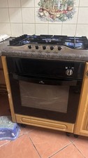 wooden kitchen units with built in cooker gas, sink, mixer tap, worktops