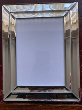 Photo frame in bevelled mirror