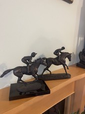 Two Sculptures Of Jockeys Atop
