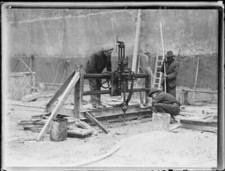 Three workers cutting into the