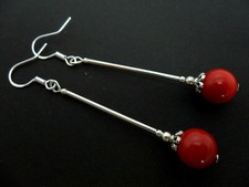 A PAIR OF LONG RED CORAL BEAD