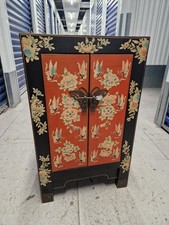 Chinese red and polychrome lacquered two door cabinet with butterfly lock plate