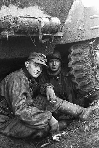 Two soldiers resting under - resting,