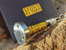 Genuine F1 car part. Team Lotus polished brake mounting bolt keyring 