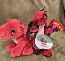 TWO RED DRAGON PLUSH SOFT TOYS ONE WITH RAINBOW WINGS AND THE OTHER AURORA VCG