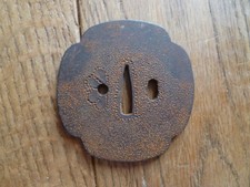 antique Japanese iron tsuba with stipple decoration.
