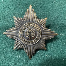 Irish Guards blackened brass Cap Badge.  Q96