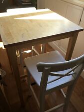 Ikea solid birchwood dining table and pair of white Ingolf chairs