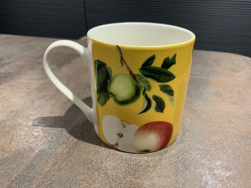 Glossy yellow mug with - mug, apples
