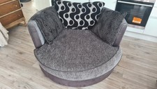 Swivel Cuddle Chair. Dark Brown Leather Base With Gret And Black Fabric.