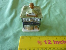 A CERAMIC MATCHSTICK HOLDER IN THE FORM OF A TOWN HOUSE