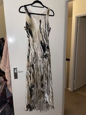 Beautiful silk asymmetrical dress with drop waist, beading and rose appliqué.