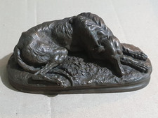 Heavy A Deva. Recumbent greyhound, brown patinated bronze, signed, 15cm W(4-2-6)