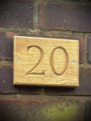 House number sign with - house, hand