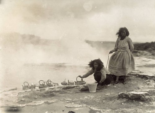 Maori women cooking food and