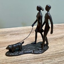 Metal Couple Walking Dog