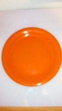 john tams dinner plate. 10 inch diameter. plain orange glaze.