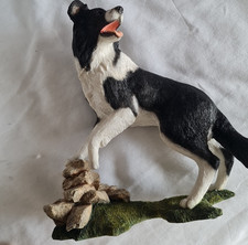 Country Artists Top Dogs - Border Collie jumping over wall