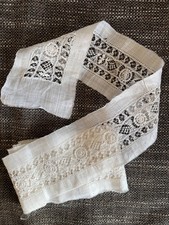 Long length of decorative white vintage lace with linen type edging