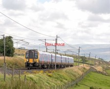 PHOTO  CLASS 350 AN EDDIE STOBART LORRY ON THE ADJACENT M6 HAS DIFFICULTY KEEPIN