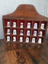 commemorative thimbles displayed in a wooden case