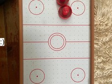 Red and white air hockey table